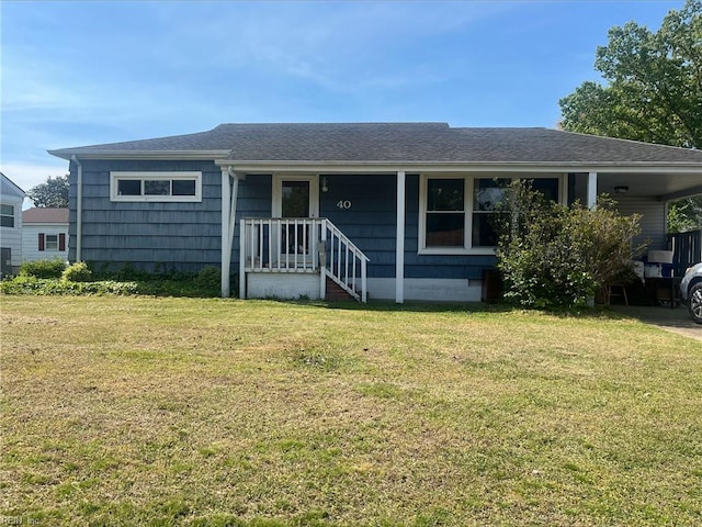 single story home with a front yard, a shingled roof, and an attached carport