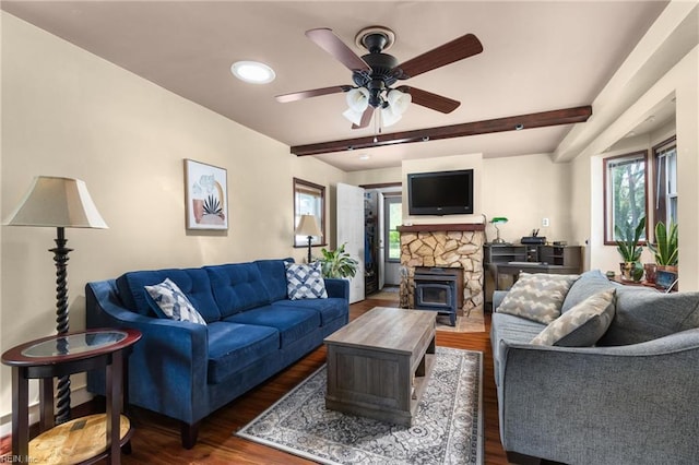 living room featuring beam ceiling, a ceiling fan, plenty of natural light, and dark wood-style floors