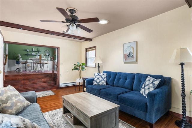 living room with wood finished floors, a ceiling fan, baseboard heating, and baseboards