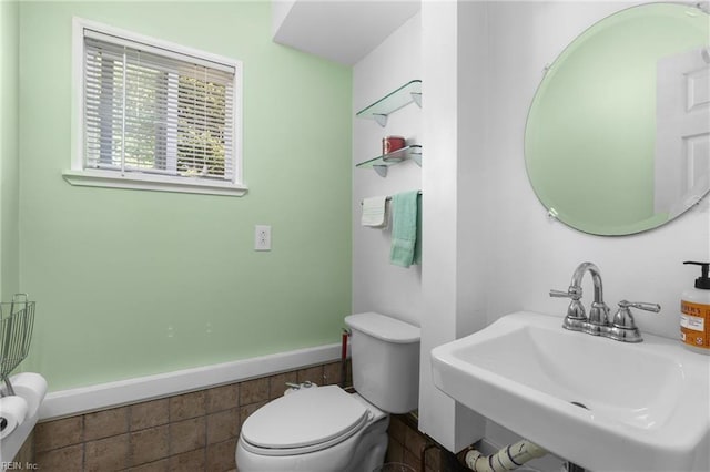 bathroom featuring toilet and a sink