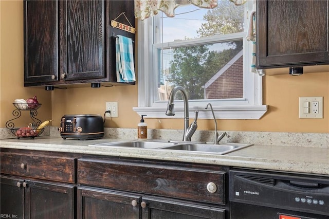 kitchen with black dishwasher, light countertops, dark brown cabinets, and a sink