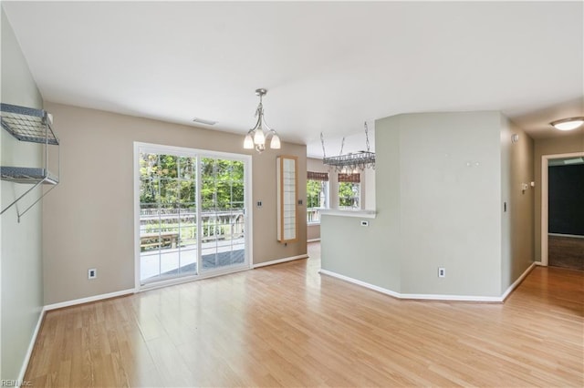 interior space with visible vents, light wood finished floors, and baseboards