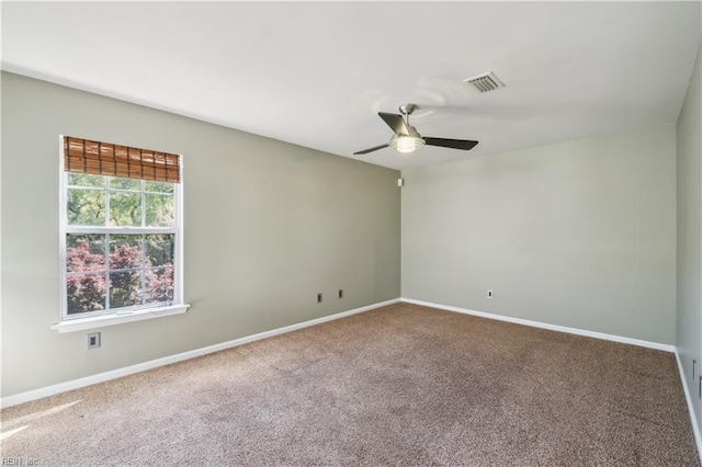 spare room with baseboards, visible vents, a ceiling fan, and carpet flooring
