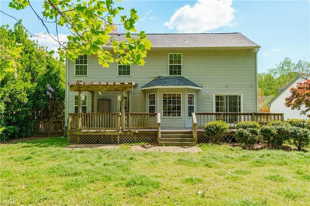 back of house with a pergola, a deck, a yard, and fence
