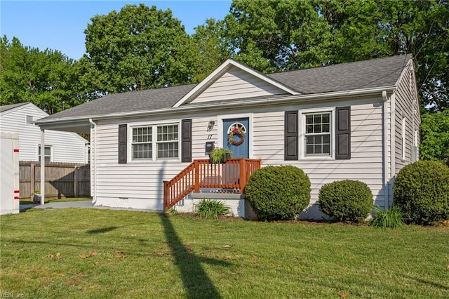 view of front of house with fence, a shingled roof, crawl space, and a front lawn