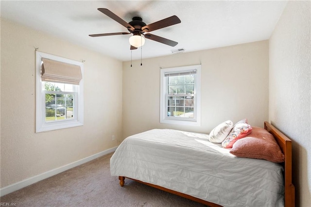 bedroom featuring carpet, visible vents, ceiling fan, and baseboards