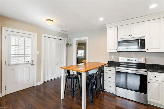 kitchen featuring white cabinetry, stainless steel appliances, and a healthy amount of sunlight