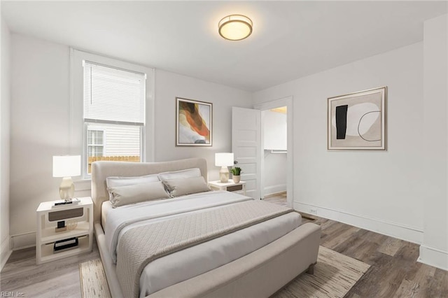 bedroom with baseboards and light wood-style floors