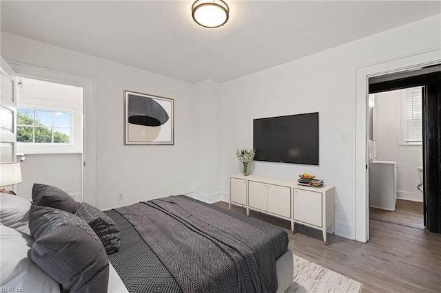 bedroom with baseboards and light wood-style floors