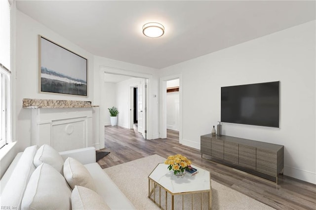 living room featuring wood finished floors and baseboards