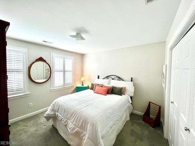 bedroom featuring baseboards, visible vents, carpet, and a closet