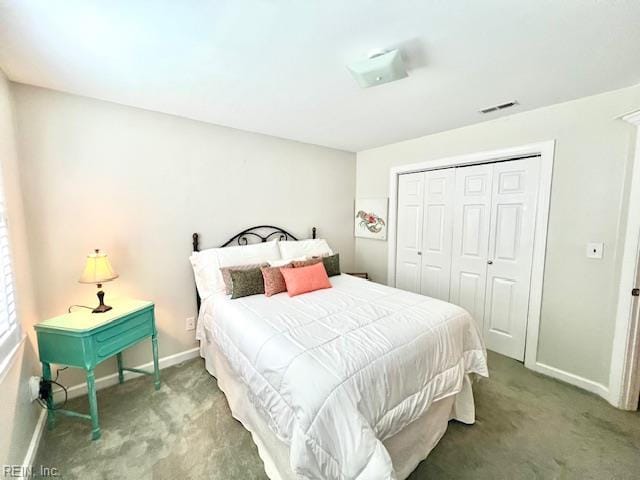 carpeted bedroom featuring baseboards, visible vents, and a closet
