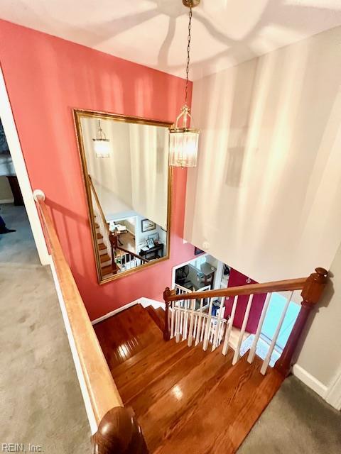 stairs featuring carpet floors and baseboards