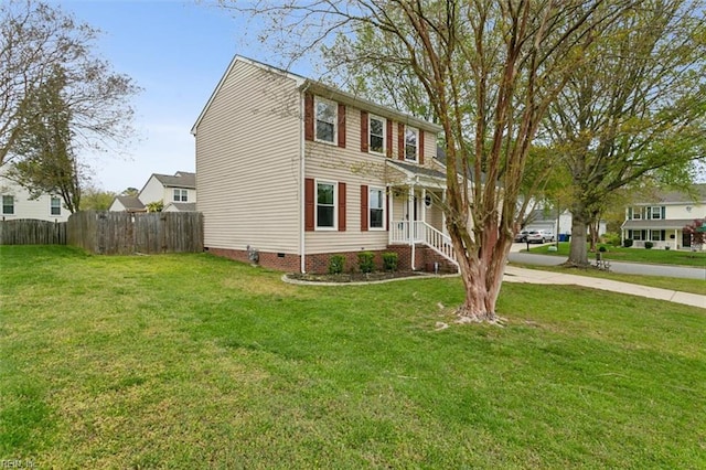 view of front of property with a front yard, driveway, crawl space, and fence