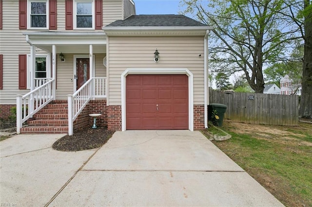traditional home with brick siding, fence, a shingled roof, a garage, and concrete driveway