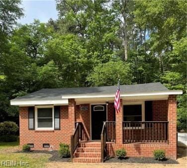 view of front facade with covered porch and brick siding
