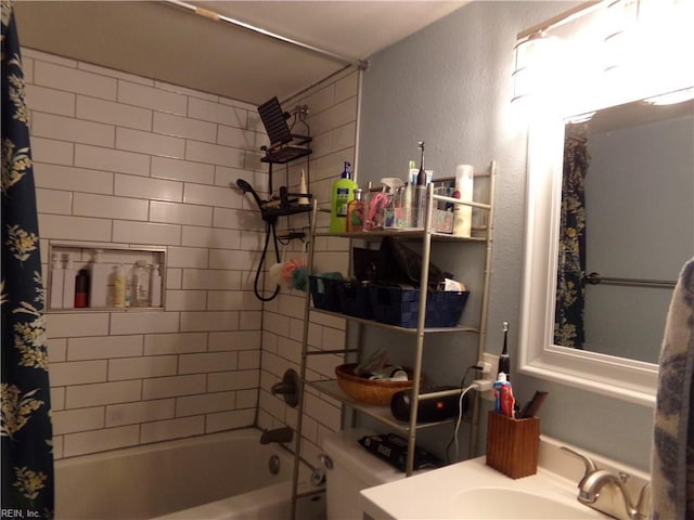 bathroom featuring shower / bathtub combination with curtain, toilet, a textured wall, and vanity