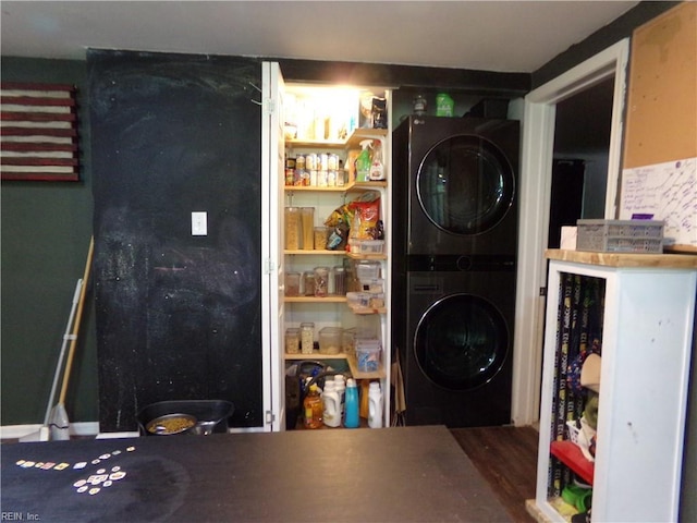 laundry room with stacked washing maching and dryer and laundry area