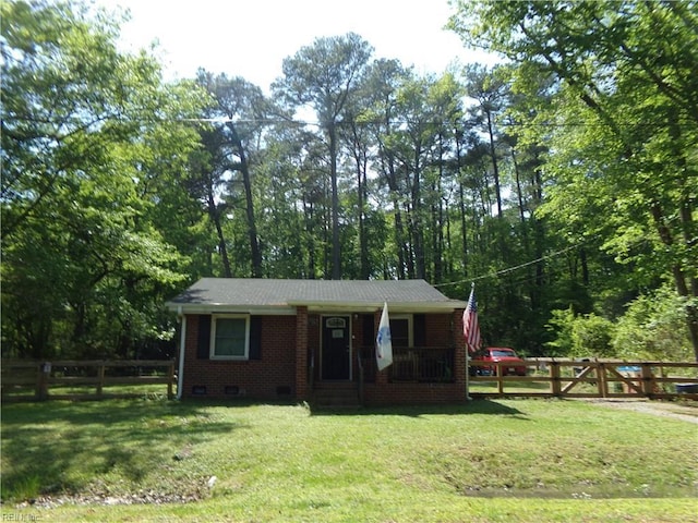 ranch-style home featuring fence private yard, a front yard, crawl space, a porch, and brick siding