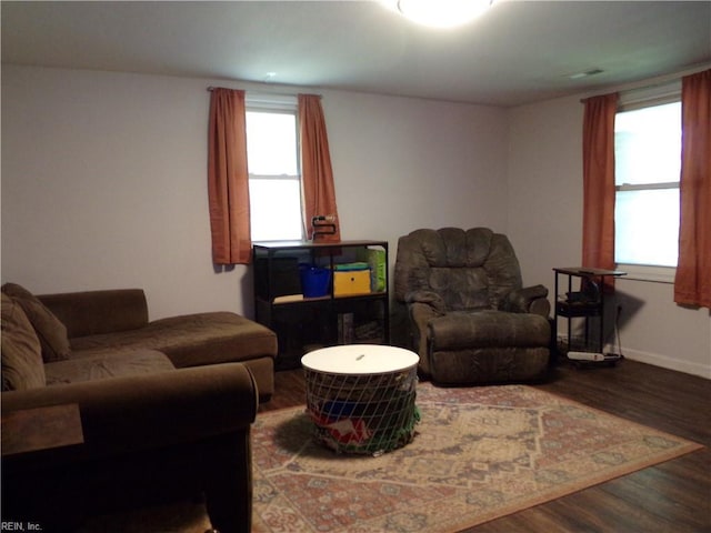 living area featuring baseboards and wood finished floors