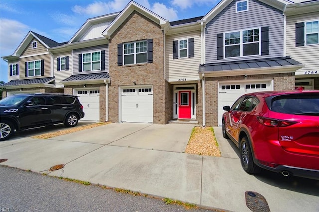 4768 Kilby Dr, Virginia Beach, VA 23456 - view of property with a standing seam roof, metal roof, driveway, brick siding, and an attached garage