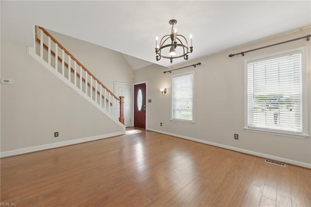 entryway with stairs, visible vents, a chandelier, and plenty of natural light