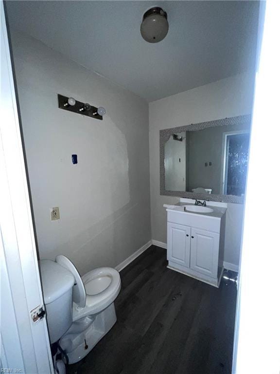 32069 Wilson St, Boykins, VA 23827 - half bath with baseboards, wood finished floors, toilet, and vanity