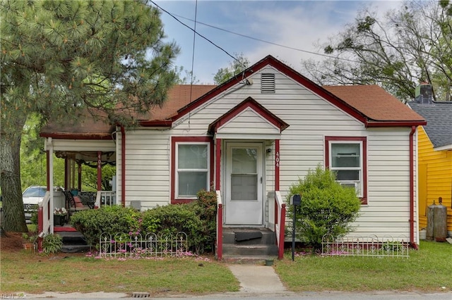 bungalow-style home with a front yard