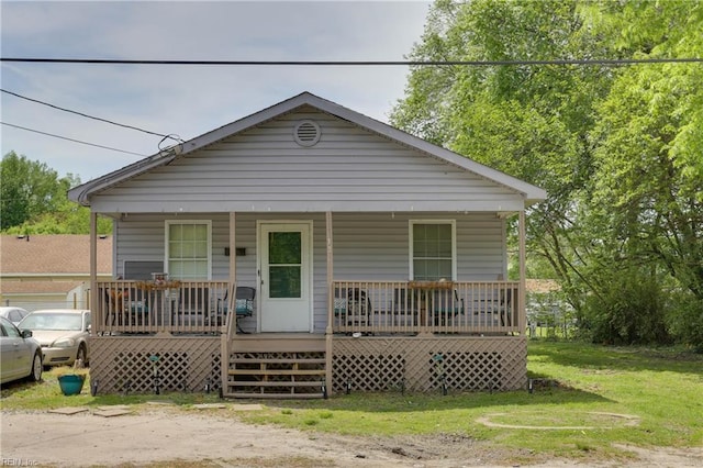 bungalow-style house featuring a porch and a front lawn