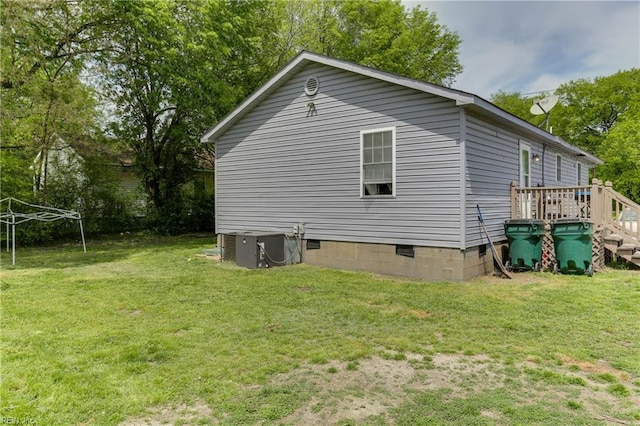 view of property exterior with crawl space, a yard, and central AC