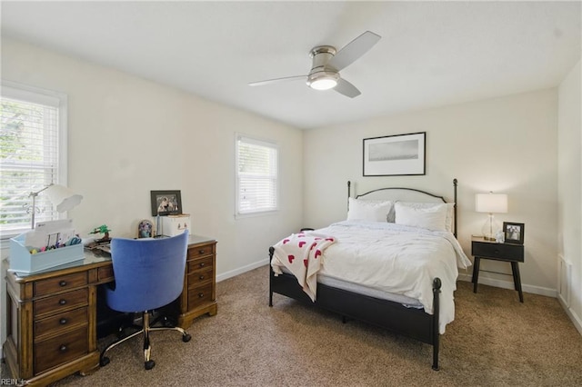 carpeted bedroom featuring ceiling fan and baseboards