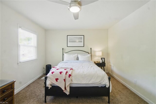 carpeted bedroom featuring ceiling fan and baseboards