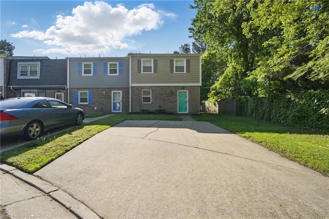 view of front of home with a front lawn and brick siding