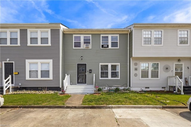 townhome / multi-family property featuring a front yard and crawl space
