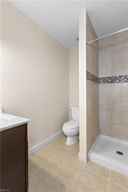 full bath with tile patterned floors, a stall shower, toilet, and vanity