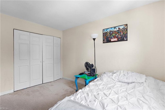 unfurnished bedroom with a closet, carpet floors, and baseboards