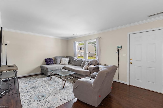 living area with ornamental molding, visible vents, baseboards, and dark wood finished floors