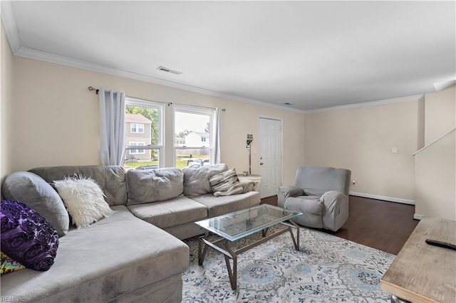 living room featuring baseboards, visible vents, wood finished floors, and crown molding