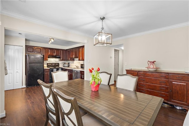 dining space with crown molding, a notable chandelier, and dark wood finished floors