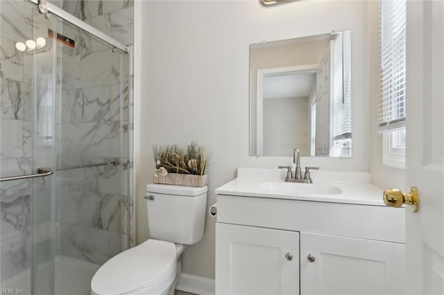full bath with a marble finish shower, toilet, and vanity