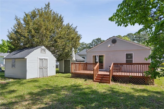 rear view of house featuring an outbuilding, a lawn, a deck, and a storage unit