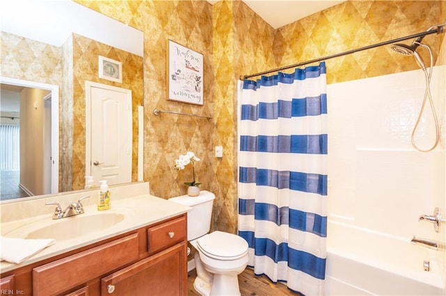 full bathroom featuring toilet, shower / bath combo, wood finished floors, and vanity