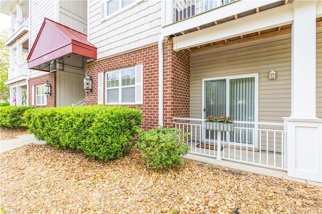 property entrance featuring brick siding