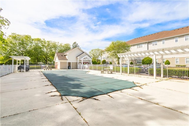 community pool with a pergola, a patio area, and fence