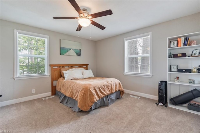 bedroom featuring baseboards, ceiling fan, and carpet