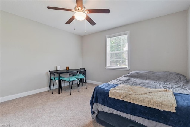 carpeted bedroom featuring baseboards and a ceiling fan