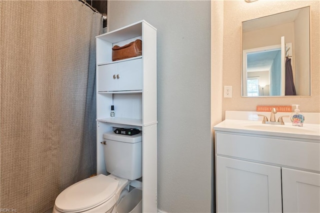 bathroom with vanity, curtained shower, and toilet