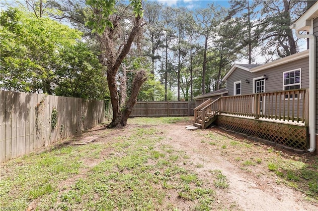 view of yard featuring a fenced backyard and a deck