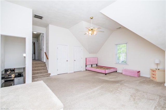 unfurnished bedroom with visible vents, a ceiling fan, lofted ceiling, baseboards, and carpet flooring