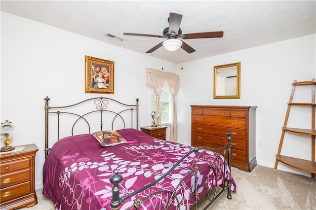 bedroom with baseboards, ceiling fan, light carpet, and visible vents